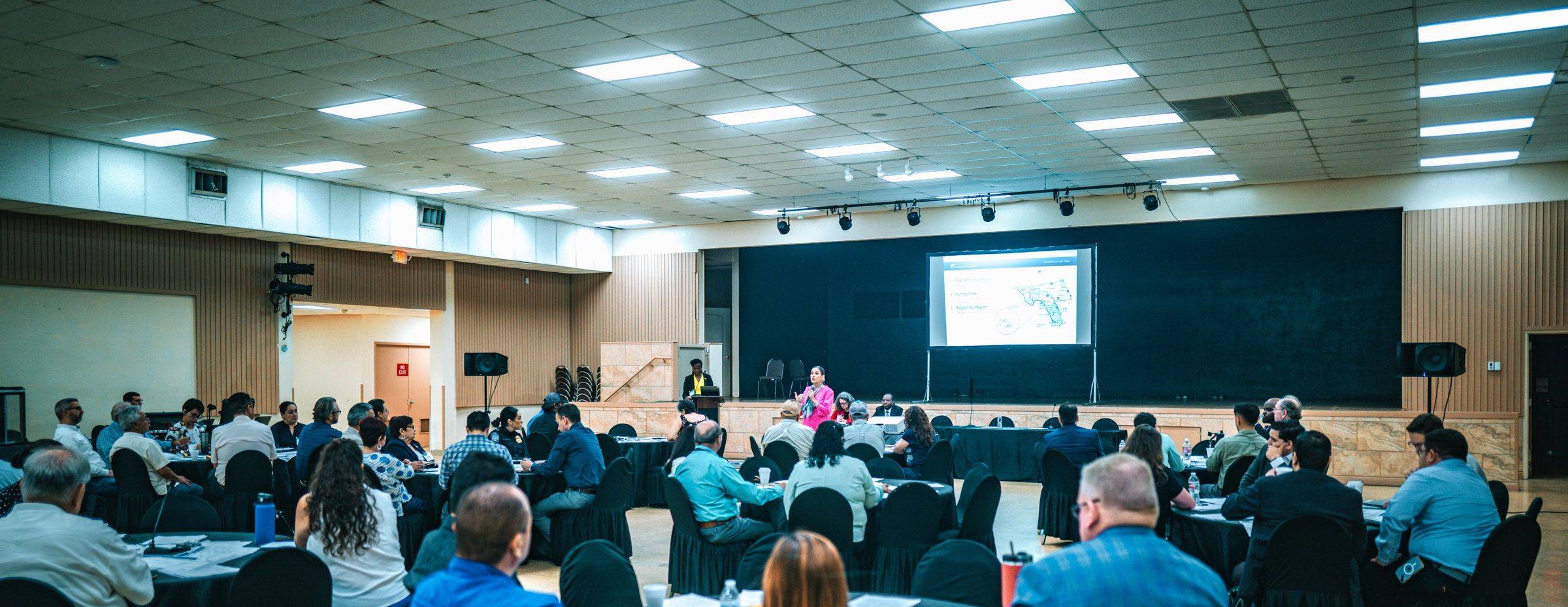 A full hall at an institutional program