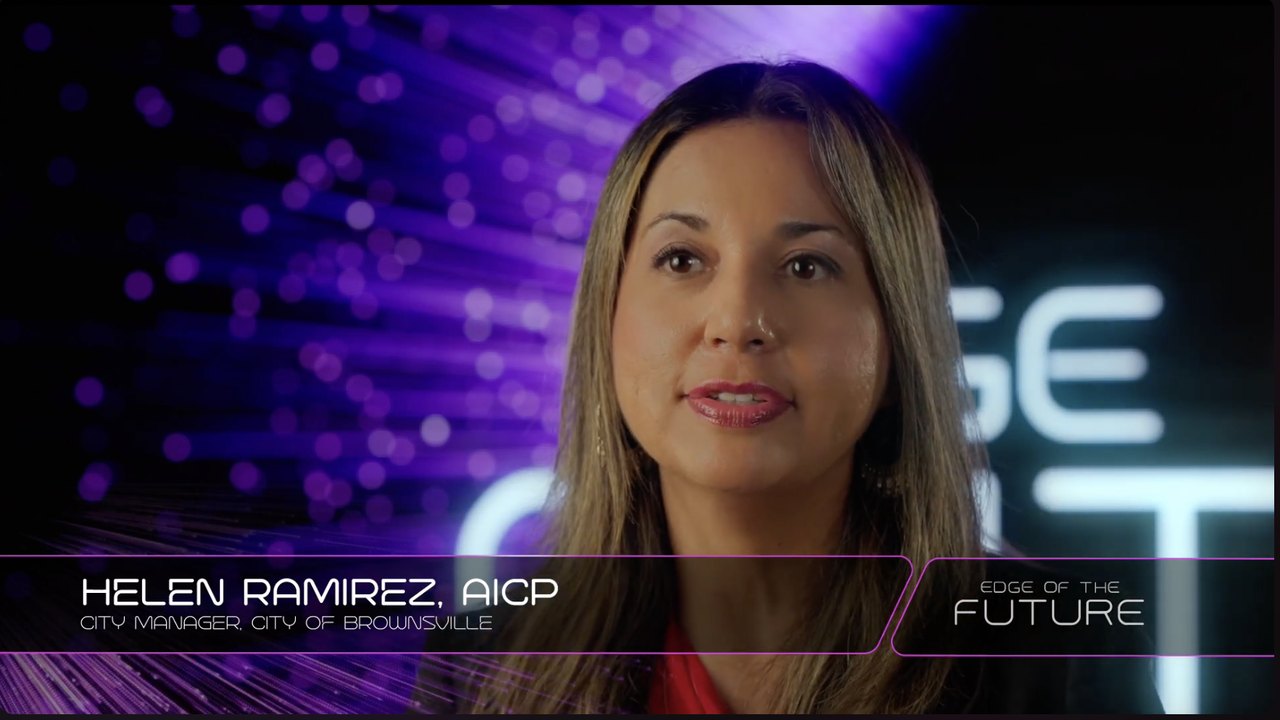 A broadcast lower third naming the City Manager, set in the program's custom title design
