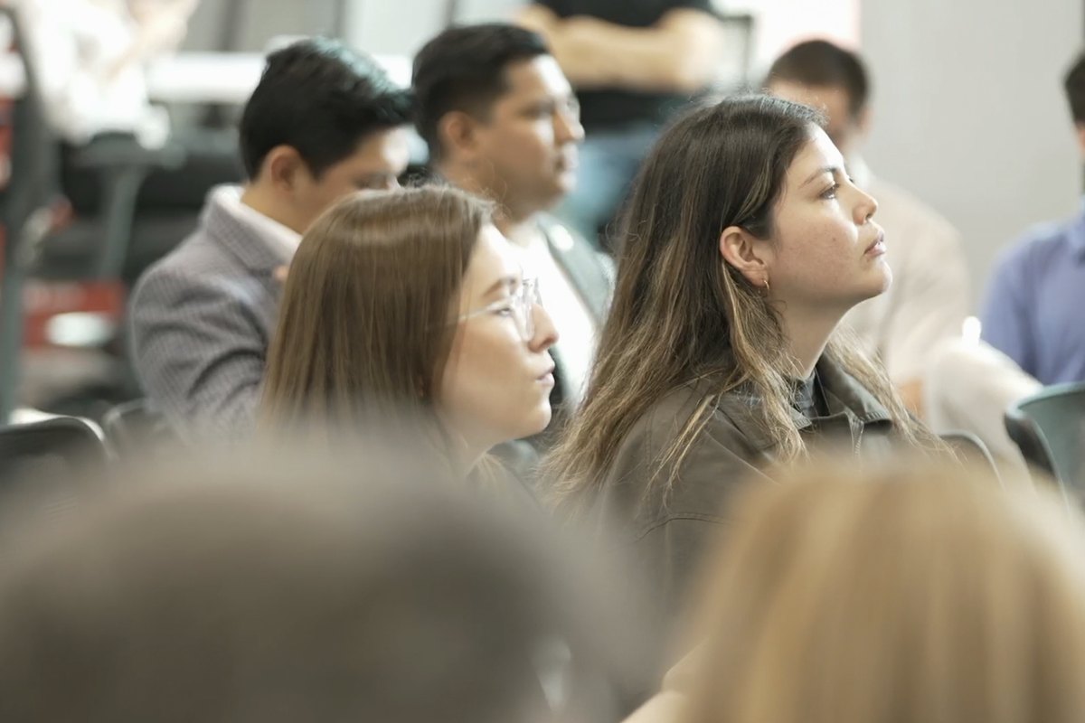 Attendees watching a session from the audience