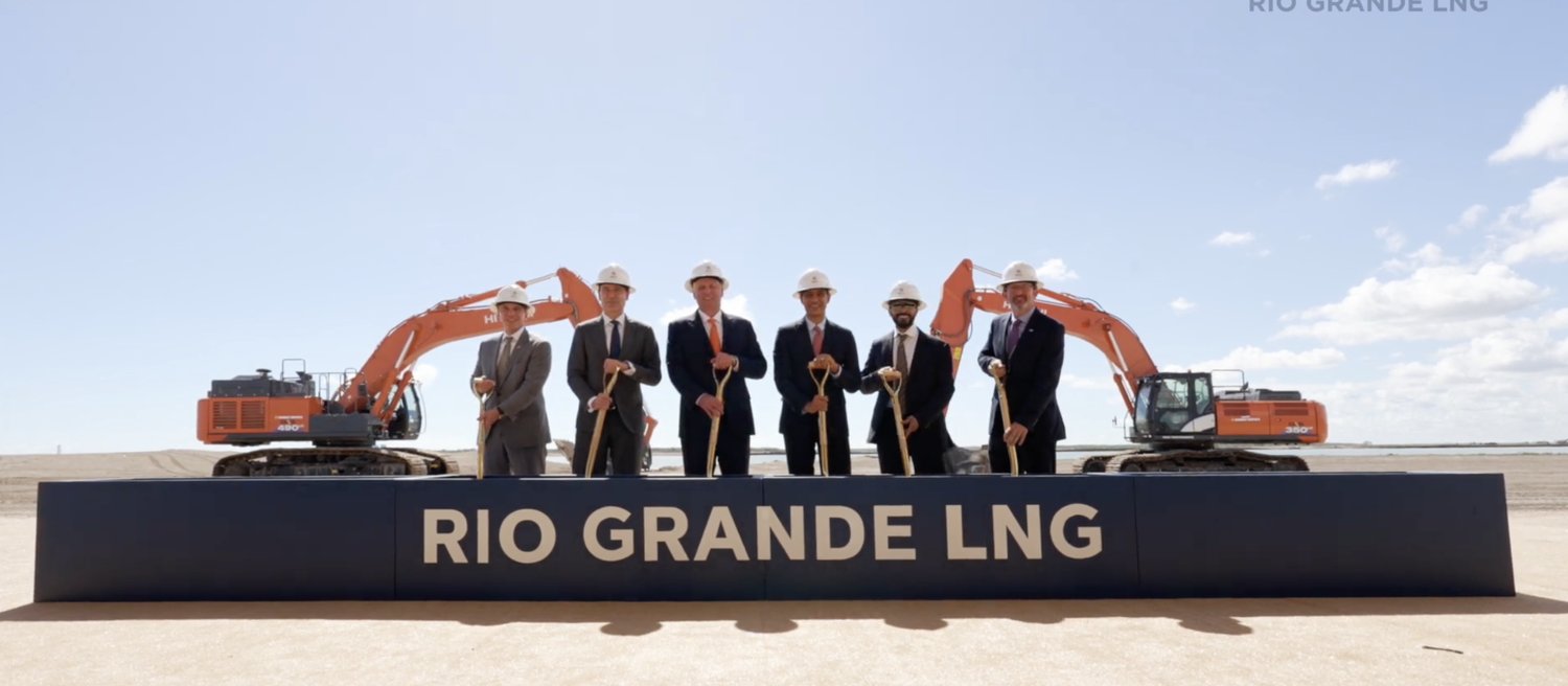 Executives turning ceremonial shovels at an industrial groundbreaking produced by Atelier near Brownsville